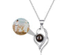 Silver phote projection necklace with a brown gemstone pendant on a white background 
