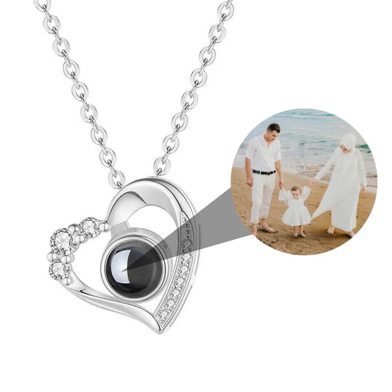 Heart-shaped necklace with a black gemstone and family photo inset
